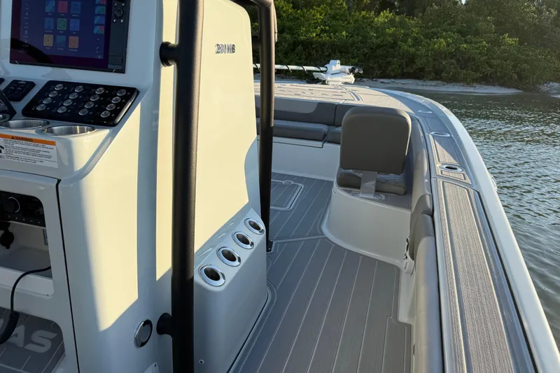 Slide: The Image of 2025 Caymas 281 HB boat interior with control panel, seating, and water view. - 45