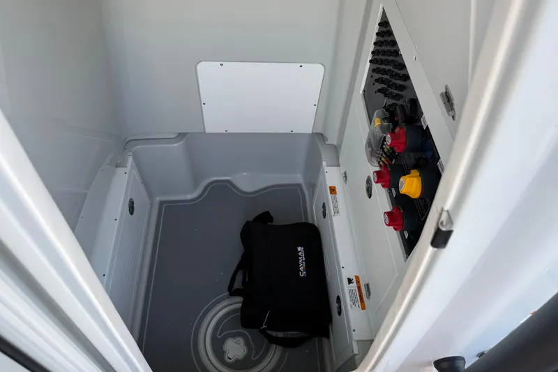 Slide: The Image of Interior view of 2025 Caymas 281 HB boat compartment with control panel and storage bag. - 48