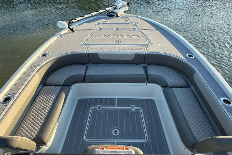Slide: The Image of 2025 Caymas 281 HB boat deck with cushioned seating, on calm water. - 50