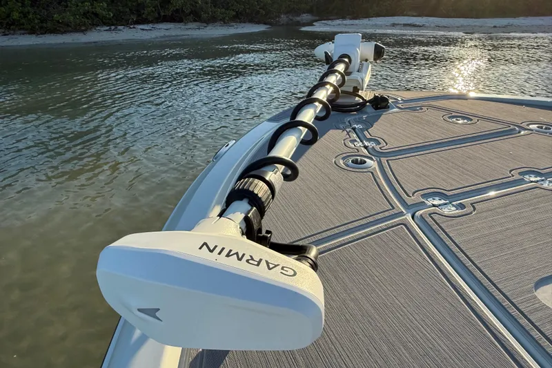 Slide: The Image of Bow of 2025 Caymas 281 HB boat with Garmin trolling motor on calm water. - 54