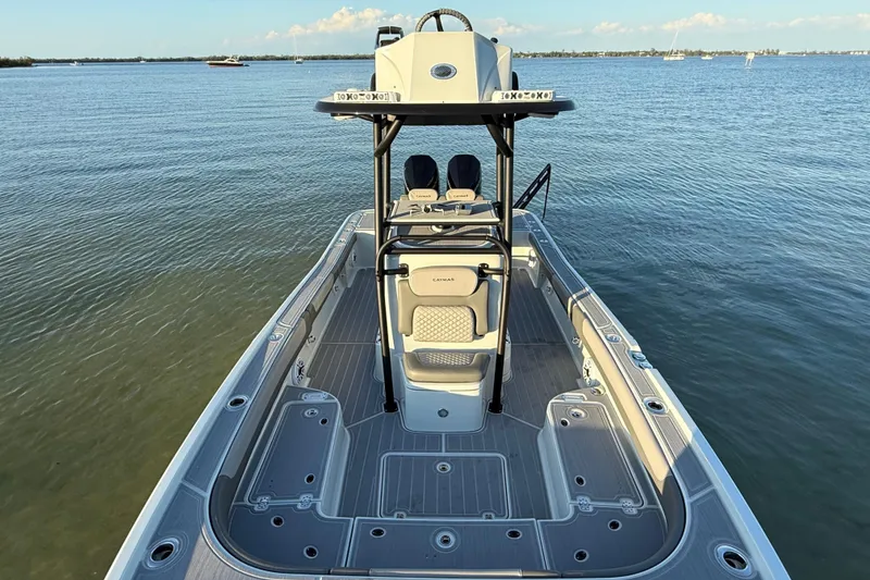 Slide: The Image of 2025 Caymas 281 HB boat on calm water, showcasing spacious deck and modern design. - 57