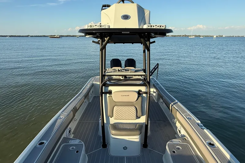 Slide: The Image of 2025 Caymas 281 HB boat on calm water, showcasing sleek design and spacious deck. - 58