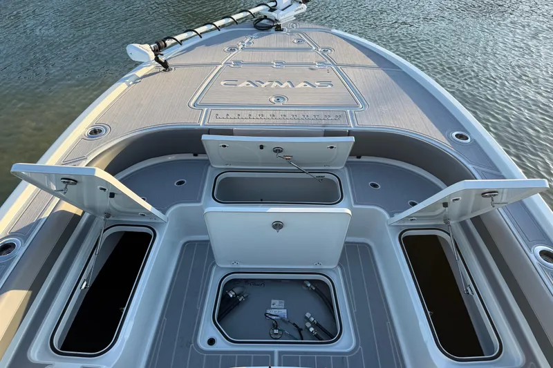Slide: The Image of 2025 Caymas 281 HB boat deck with open storage compartments on water. - 63
