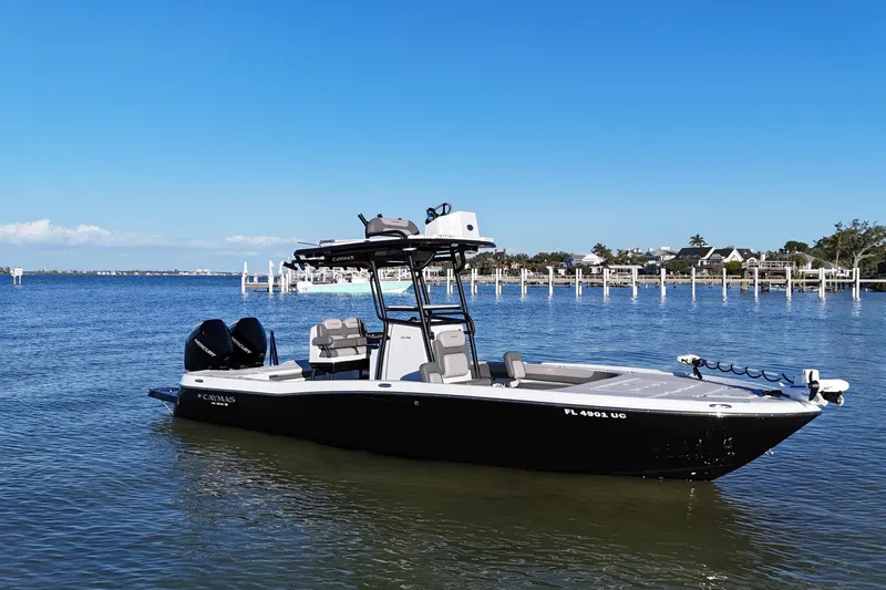 Slide: The Image of 2025 Caymas 281 HB boat on calm water, clear blue sky background. - 7