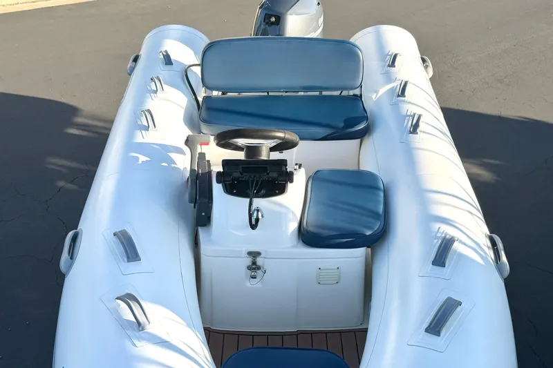 Slide: The Image of 2018 Brig Falcon 360 inflatable boat with blue seating and steering console. - 13