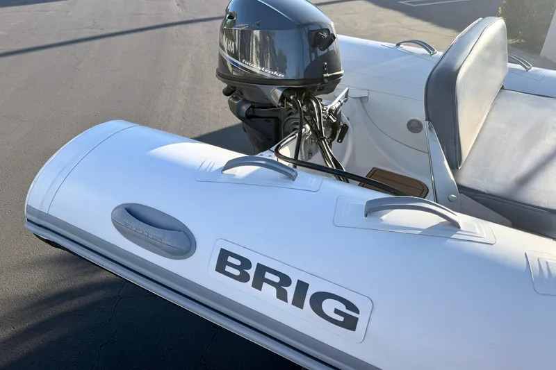 Slide: The Image of 2018 Brig Falcon 360 inflatable boat with Yamaha outboard motor, parked on pavement. - 15