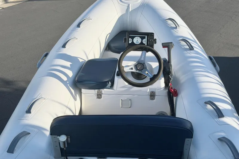 Slide: The Image of 2018 Brig Falcon 360 inflatable boat interior with steering wheel and seating. - 18