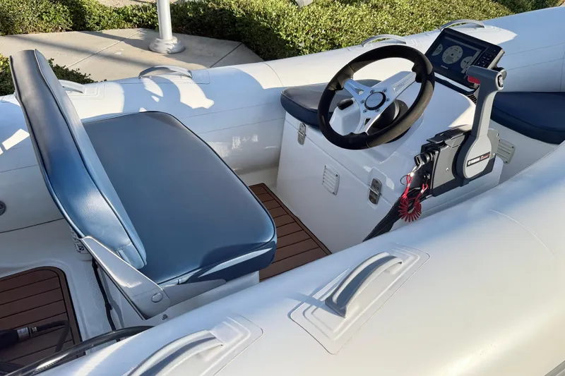 Slide: The Image of 2018 Brig Falcon 360 boat interior with steering wheel and control panel. - 21