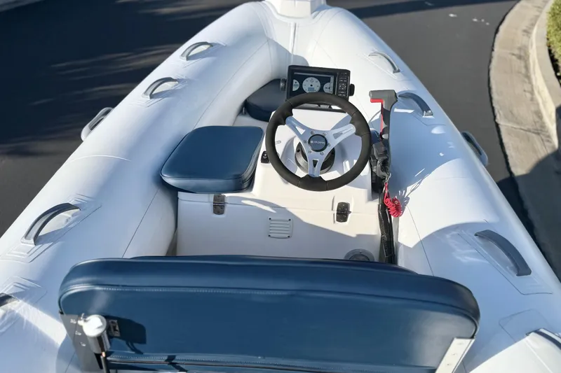 Slide: The Image of 2018 Brig Falcon 360 inflatable boat interior with steering wheel and seating. - 9