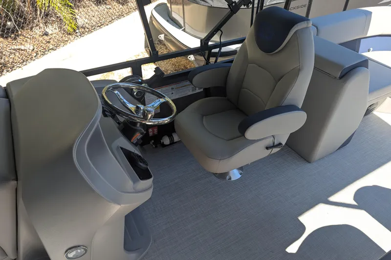 Slide: The Image of Captain's chair and steering wheel on 2026 Dockside 22DQ2.75 boat, featuring modern design. - 4