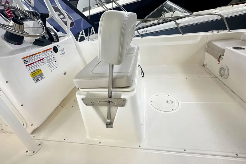 Slide: The Image of 2026 Boston Whaler 190 Montauk boat interior with steering console and seating. - 10
