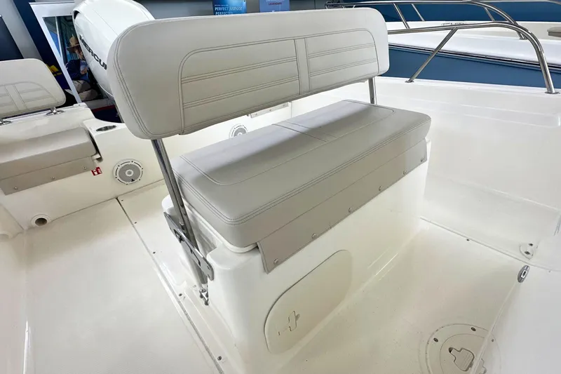 Slide: The Image of 2026 Boston Whaler 190 Montauk boat interior with cushioned seating and storage. - 11