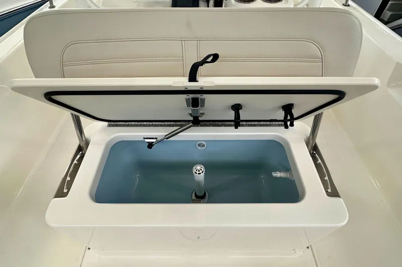 Slide: The Image of 2026 Boston Whaler 190 Montauk livewell with open lid, showcasing interior features. - 12