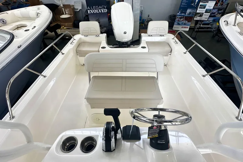 Slide: The Image of 2026 Boston Whaler 190 Montauk boat interior with steering wheel and seating. - 13
