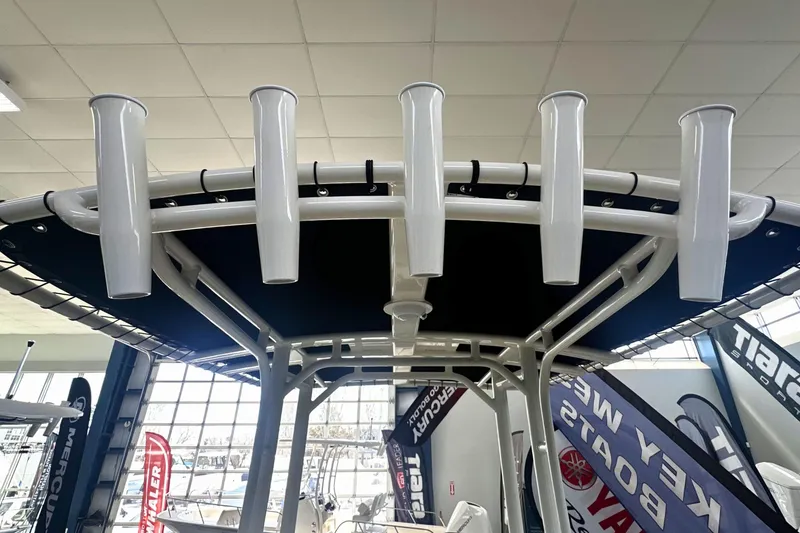 Slide: The Image of Boston Whaler 190 Montauk 2026 boat with rod holders and canopy in showroom. - 14