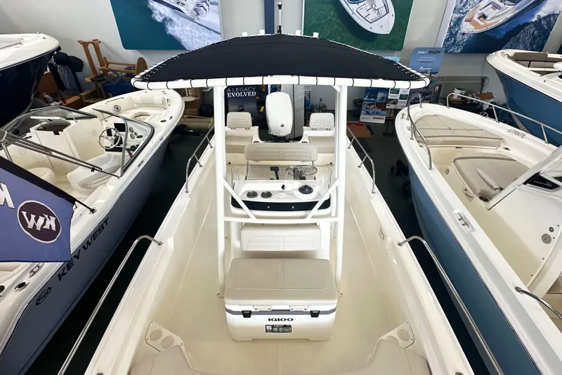 Slide: The Image of 2026 Boston Whaler 190 Montauk boat displayed in a showroom, featuring sleek design and modern amenities. - 17