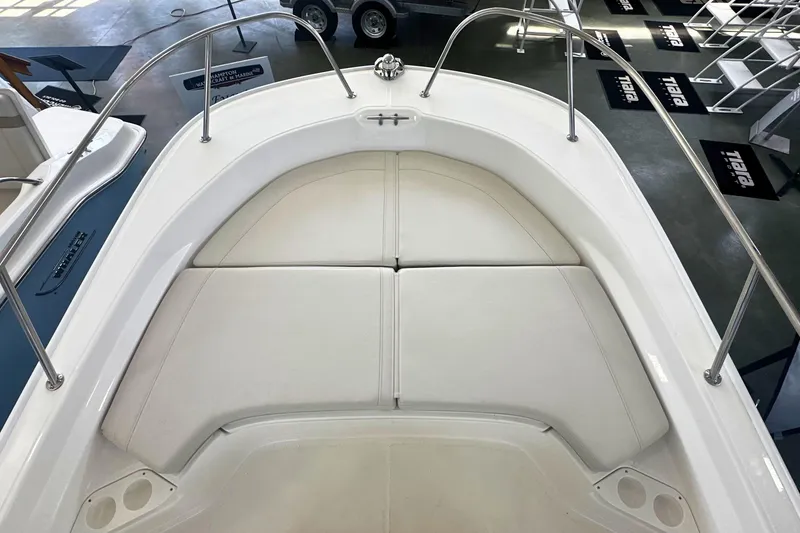 Slide: The Image of 2026 Boston Whaler 190 Montauk boat interior with cushioned seating and stainless steel railings. - 22
