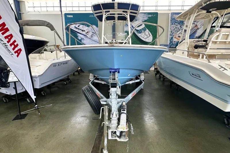 Slide: The Image of 2026 Boston Whaler 190 Montauk boat displayed in showroom, front view on trailer. - 24