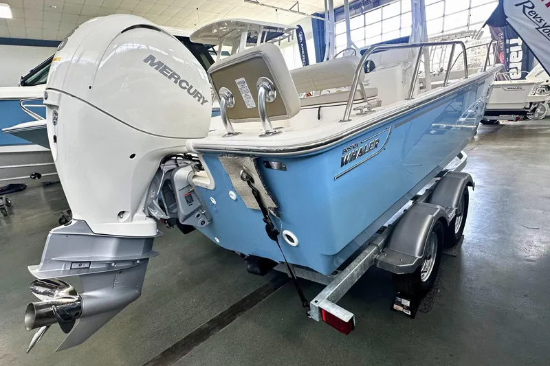 Slide: The Image of 2026 Boston Whaler 190 Montauk boat with Mercury engine on trailer in showroom. - 3