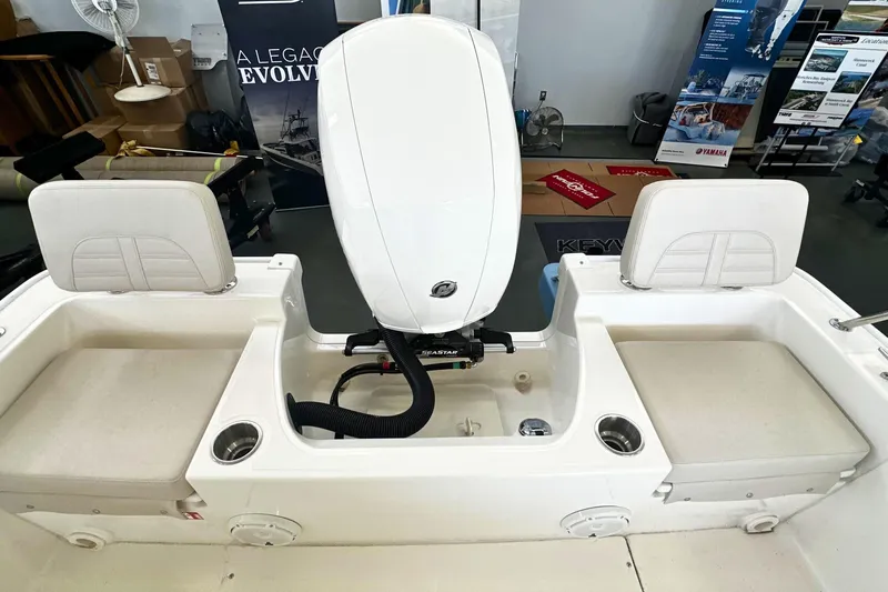 Slide: The Image of 2026 Boston Whaler 190 Montauk boat interior with engine and seating area. - 6
