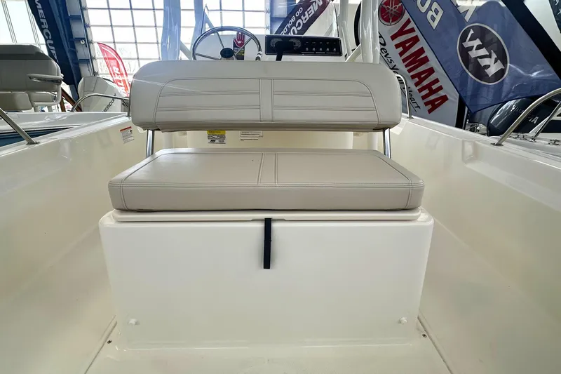 Slide: The Image of 2026 Boston Whaler 190 Montauk boat interior with beige seating and control panel. - 8