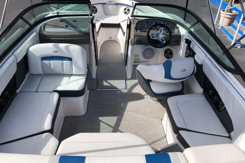 Slide: The Image of 2015 Regal 2000 ESX Bowrider interior with white and blue seating, modern dashboard, and steering wheel. - 11