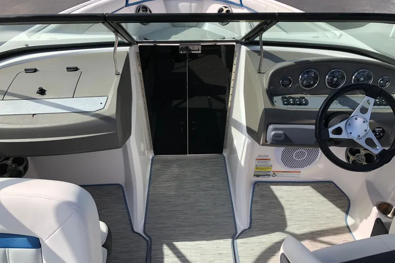 Slide: The Image of Interior view of a 2015 Regal 2000 ESX Bowrider boat cockpit with steering wheel and dashboard. - 17