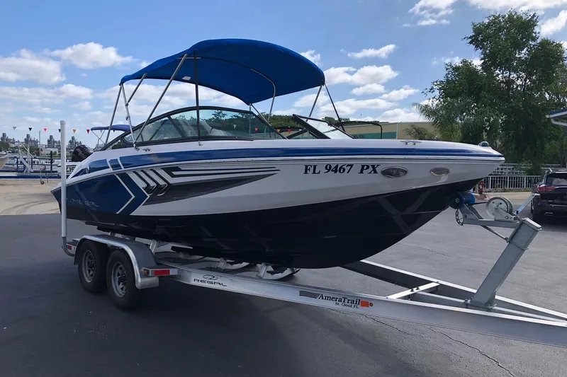 Slide: The Image of 2015 Regal 2000 ESX Bowrider on trailer, blue canopy, parked outdoors. - 3