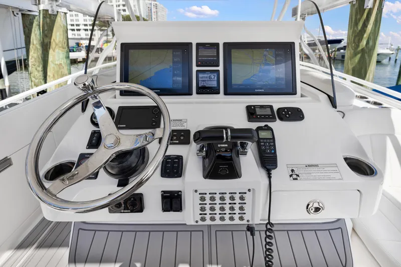 Slide: The Image of 2016 Intrepid 400 Cuddy boat helm with dual navigation screens and controls. - 14