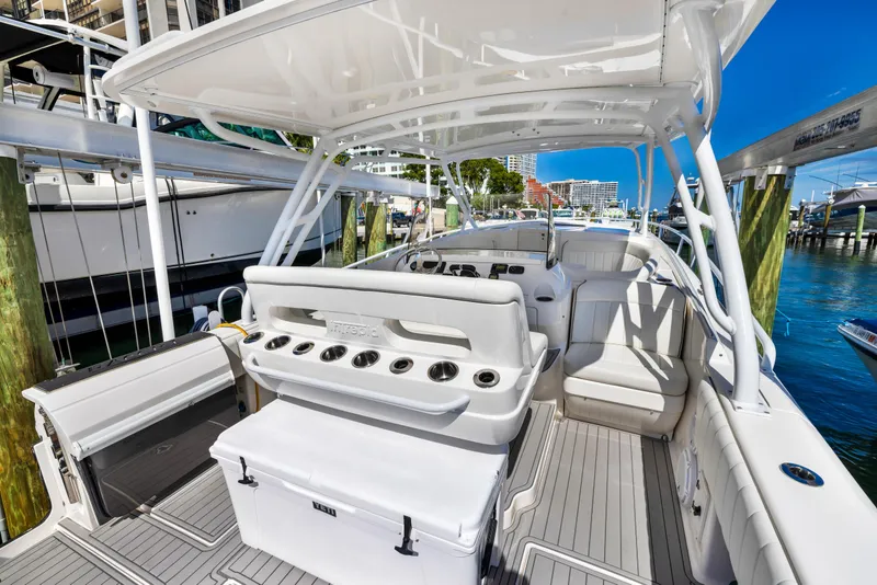 Slide: The Image of 2016 Intrepid 400 Cuddy boat interior with seating and fishing rod holders. - 16