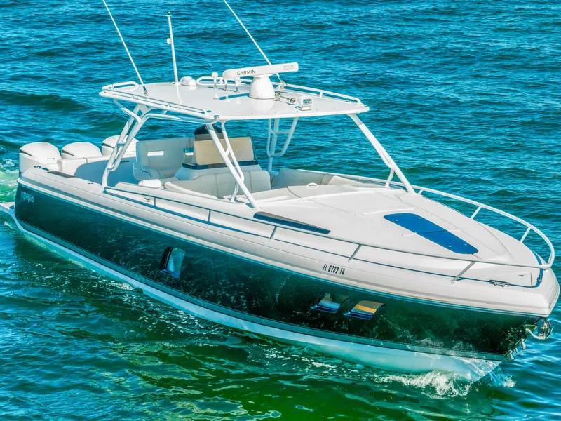 Slide: The Image of 2016 Intrepid 400 Cuddy boat cruising on blue water. - 2