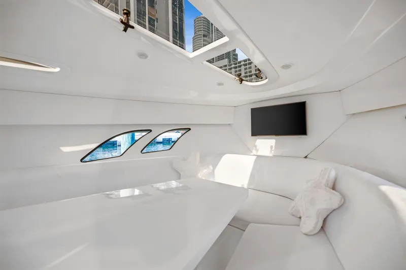 Slide: The Image of Interior of 2016 Intrepid 400 Cuddy yacht with white seating and windows. - 23