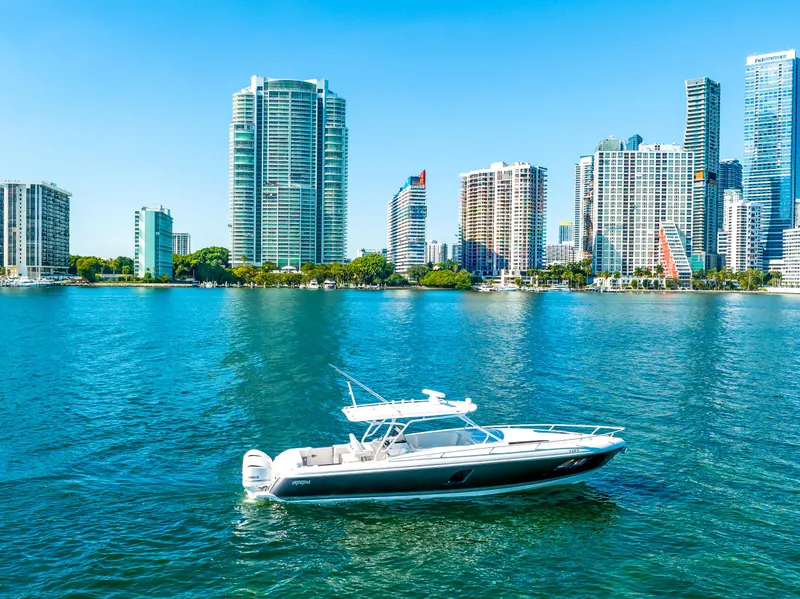Slide: The Image of 2016 Intrepid 400 Cuddy boat cruising near city skyline. - 3