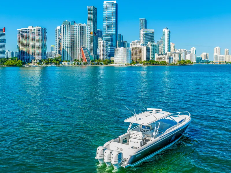 Slide: The Image of 2016 Intrepid 400 Cuddy boat cruising near a city skyline. - 4