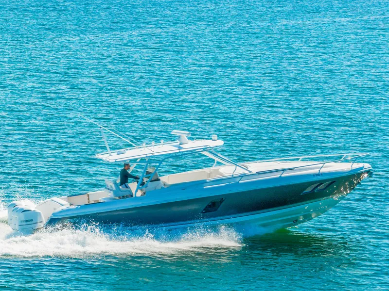 Slide: The Image of 2016 Intrepid 400 Cuddy cruising on clear blue water. - 6