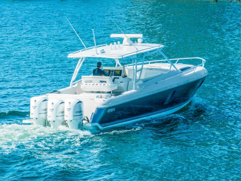 Slide: The Image of 2016 Intrepid 400 Cuddy boat cruising on blue water. - 7