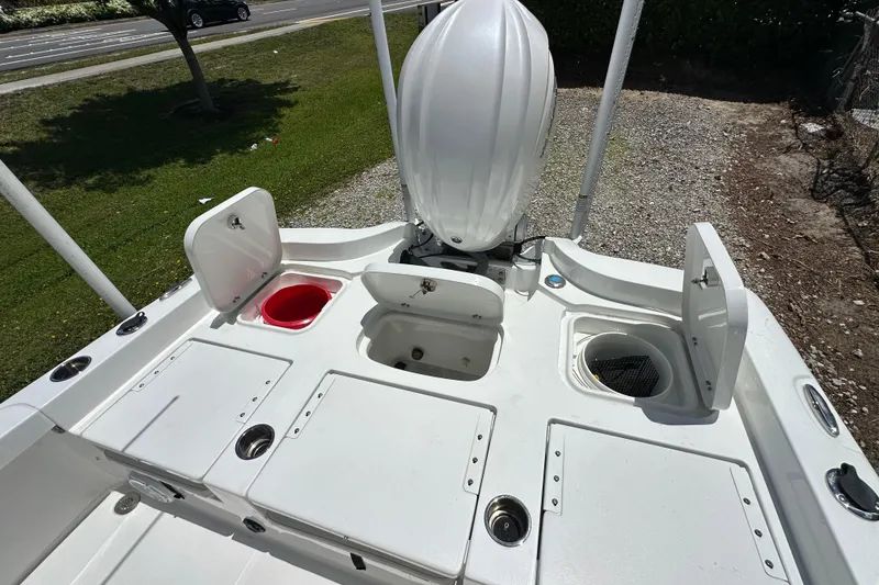 Slide: The Image of 2023 Sea Hunt BX 25 BR boat deck with storage compartments and motor. - 12
