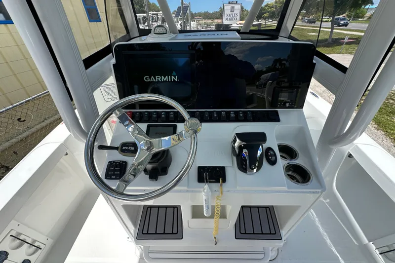 Slide: The Image of 2023 Sea Hunt BX 25 BR boat console with Garmin display and steering wheel. - 17