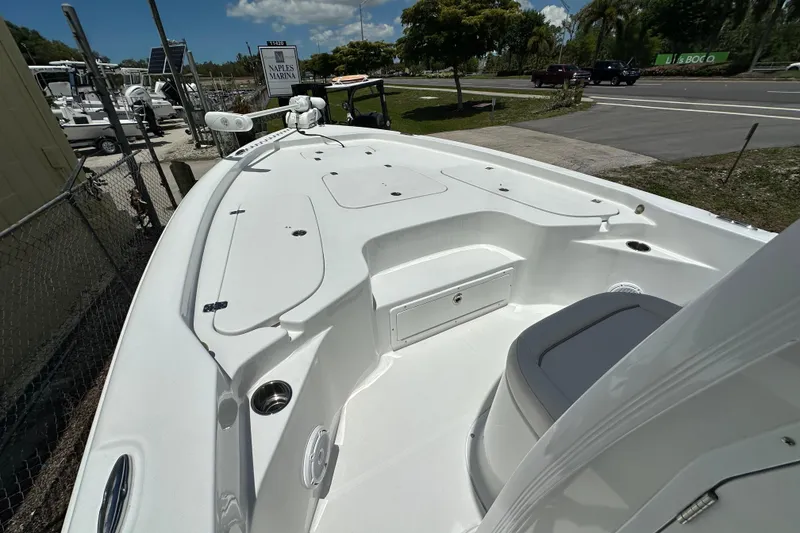 Slide: The Image of 2023 Sea Hunt BX 25 BR boat at Naples Marina, showcasing spacious deck and seating. - 21