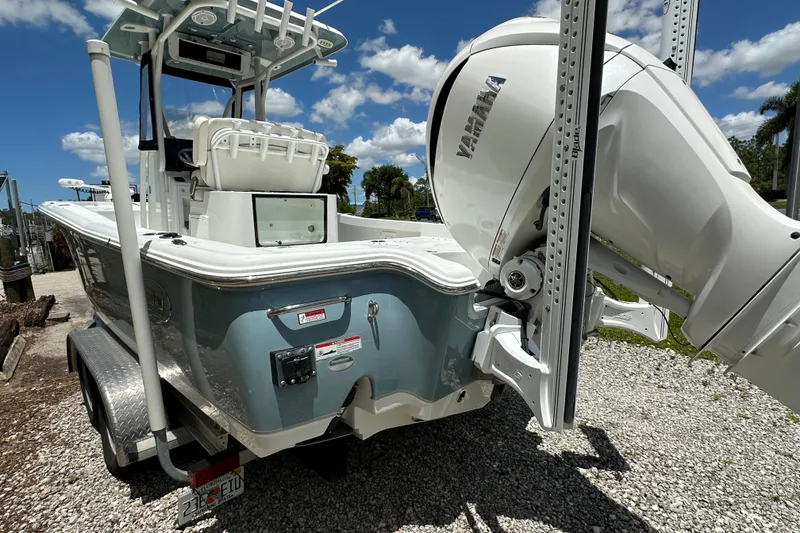 Slide: The Image of 2023 Sea Hunt BX 25 BR boat with Yamaha engine on a trailer, under a sunny sky. - 7