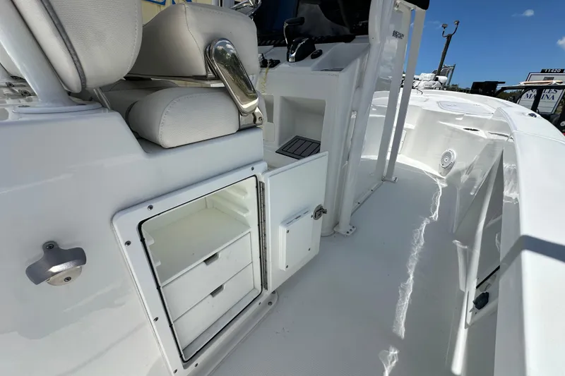 Slide: The Image of 2023 Sea Hunt BX 25 BR boat interior with storage compartments and seating. - 9