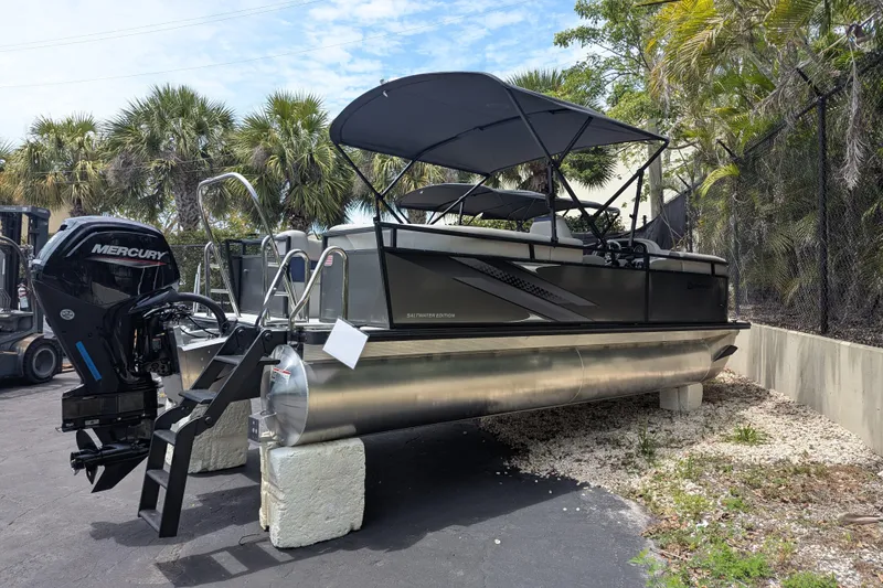 The Image of 2026 Dockside 22DQ2.75 pontoon boat with Mercury engine, parked outdoors. - 0