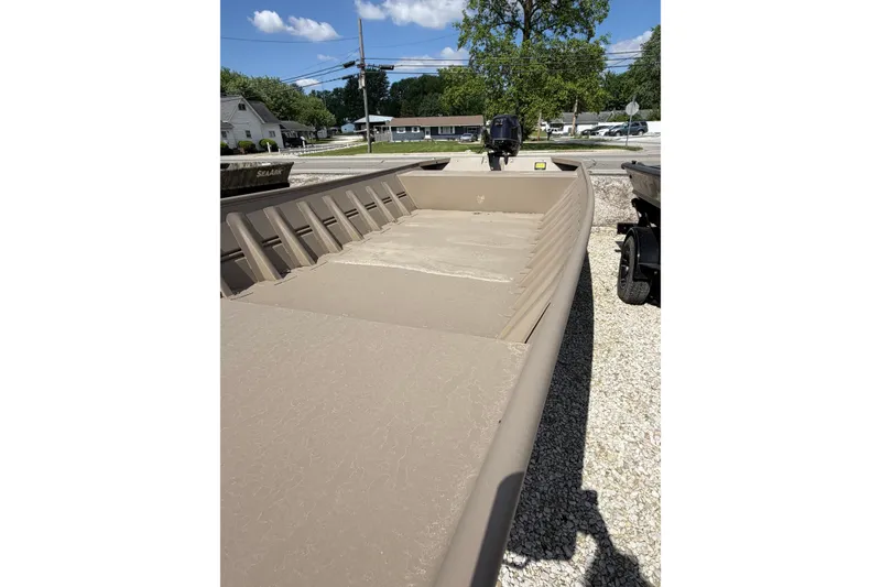 The Image of 2026 Weld-Craft 1652FN boat, beige color, parked outdoors on gravel. - 0