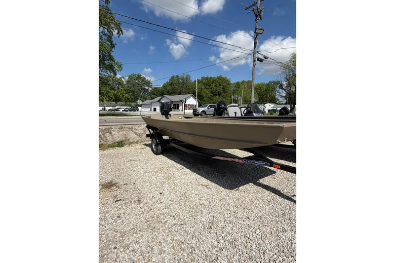 Slide: The Image of 2026 Weld-Craft 1652FN boat with Tohatsu outboard motor, parked outdoors under blue sky. - 3