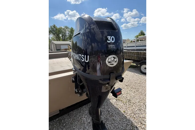 Slide: The Image of Tohatsu outboard motor on Weld-Craft 1652FN boat, 2026 model, parked on gravel. - 4