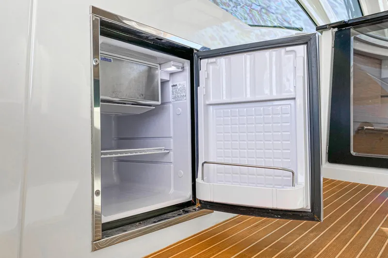 Slide: The Image of Open refrigerator on 2017 Beneteau Gran Turismo 46 yacht, showcasing interior storage space. - 10
