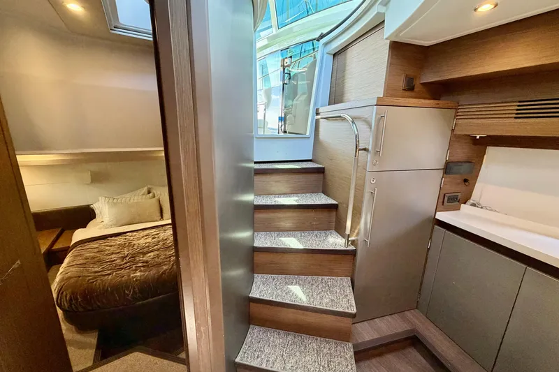 Slide: The Image of Luxurious interior of 2017 Beneteau Gran Turismo 46 yacht with modern staircase and cozy bedroom. - 12