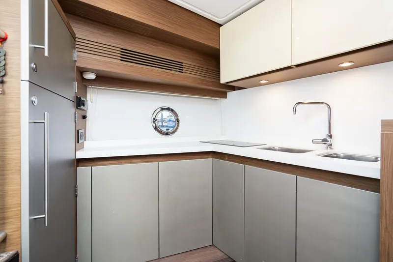 Slide: The Image of Modern kitchen interior of 2017 Beneteau Gran Turismo 46 yacht, featuring sleek cabinetry and dual sinks. - 15