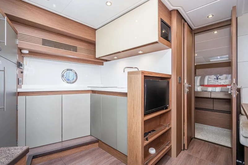 Slide: The Image of Luxurious interior of 2017 Beneteau Gran Turismo 46 yacht, featuring modern kitchen and cozy cabin. - 16
