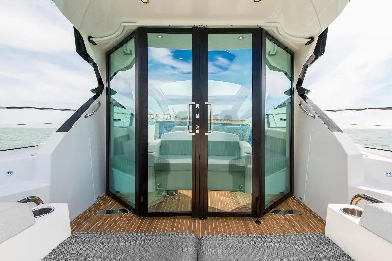 Slide: The Image of Interior view of 2017 Beneteau Gran Turismo 46 yacht with glass doors and seating area. - 2